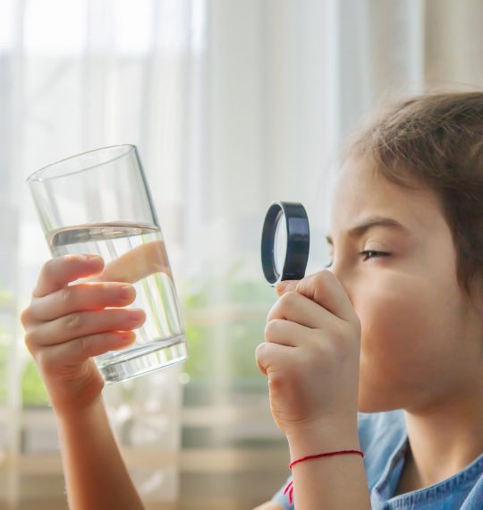 The,Child,Examines,The,Water,With,A,Magnifying,Glass,In